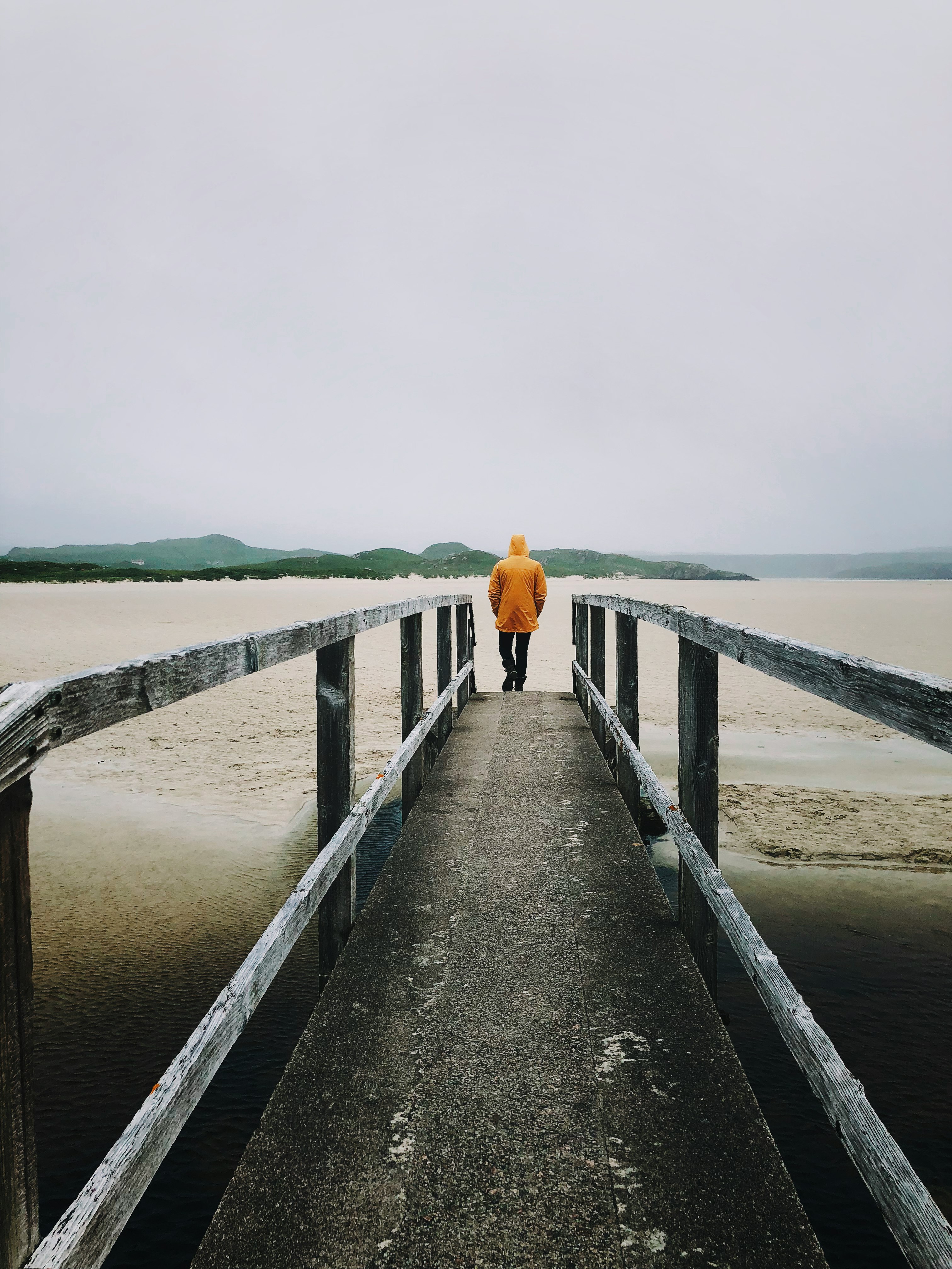 man stand on dock near body of water